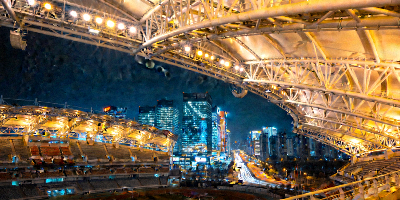 大型体育场馆夜间外景，灯光照亮看台，象征体育赛事的城市影响力